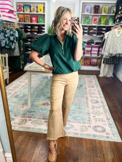 Hunter green puff-sleeve top with half-zip collar and short gathered sleeves