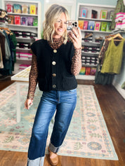 Black ribbed knit button-front sweater vest with front pockets and gold buttons