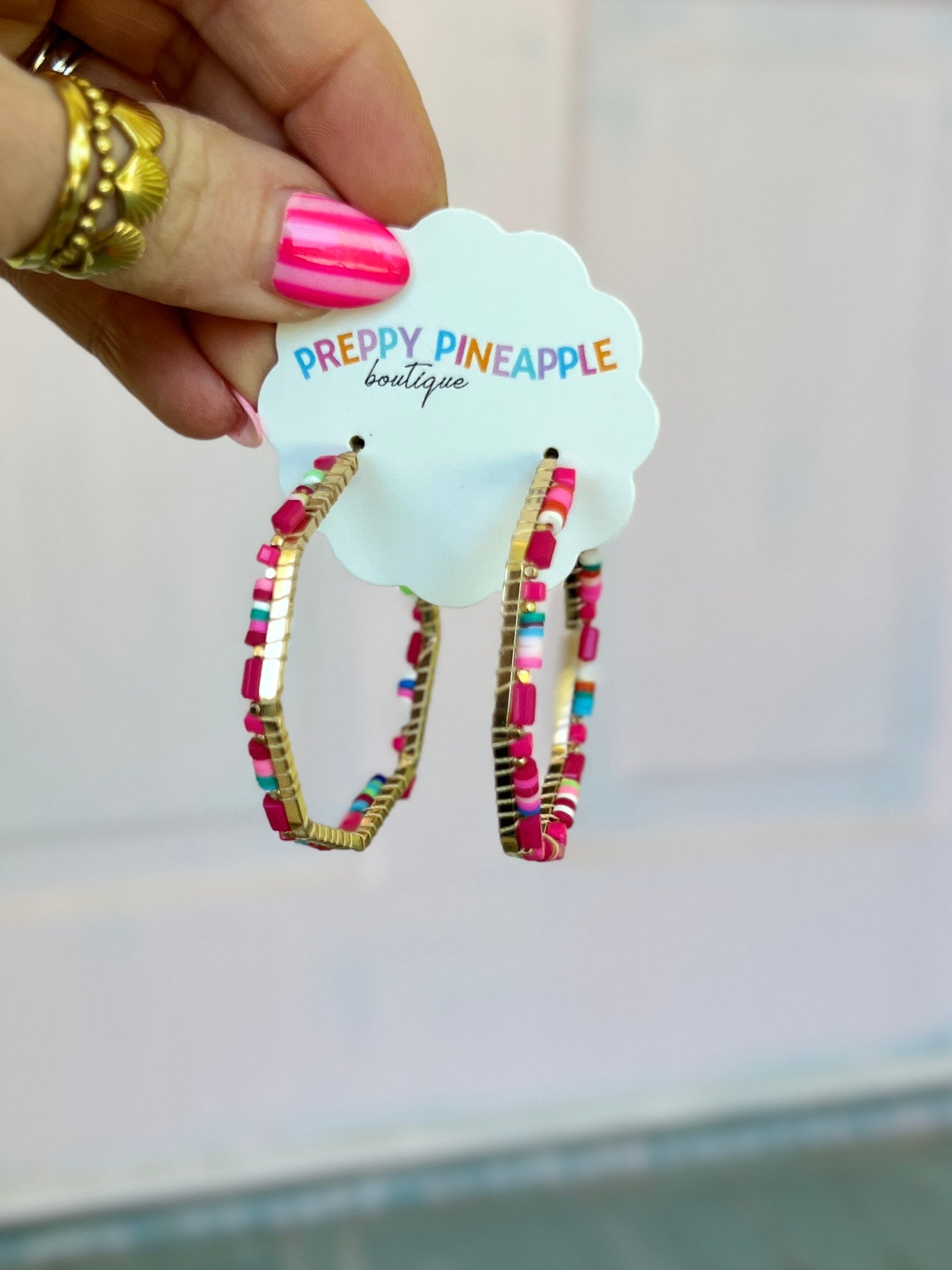 Beaded octagon hoop earrings with pink, white, and multicolor beads
