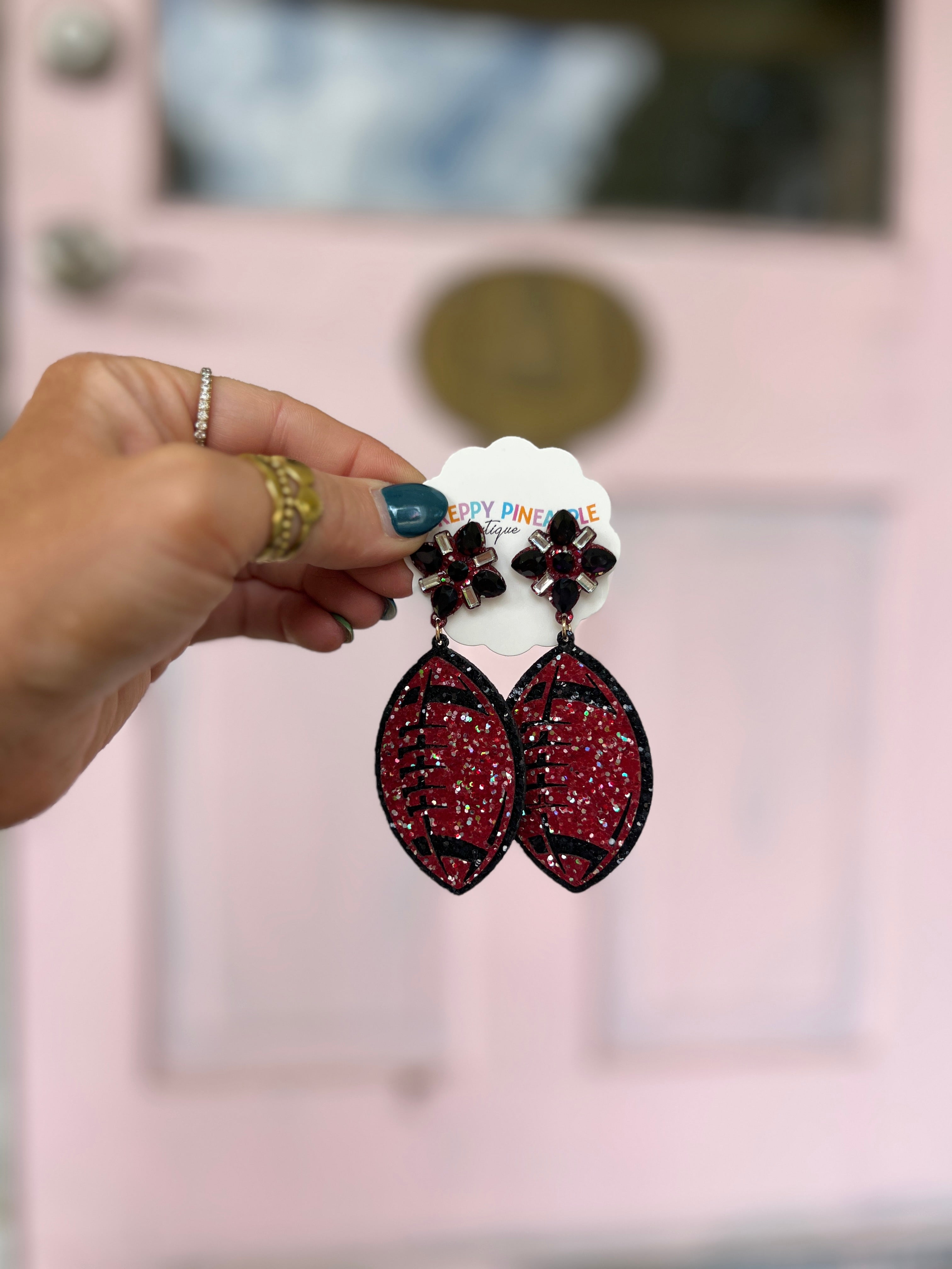 Glitter football earrings in burgundy and black, dangling