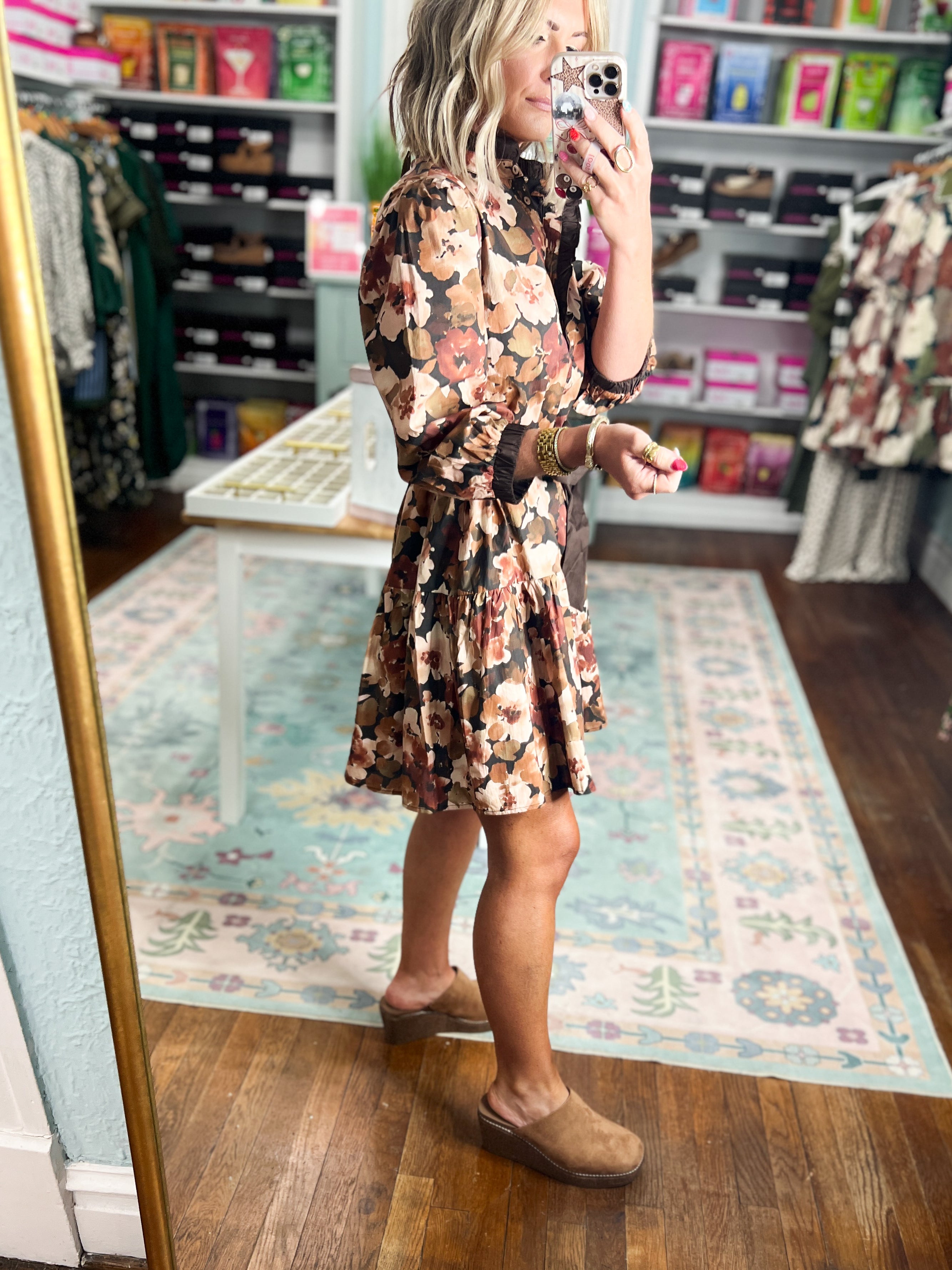 Floral midi dress with long sleeves and tie waist, black base, walking side view