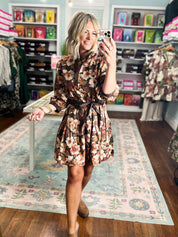 Black floral midi dress with long sleeves and tied waist, front angle