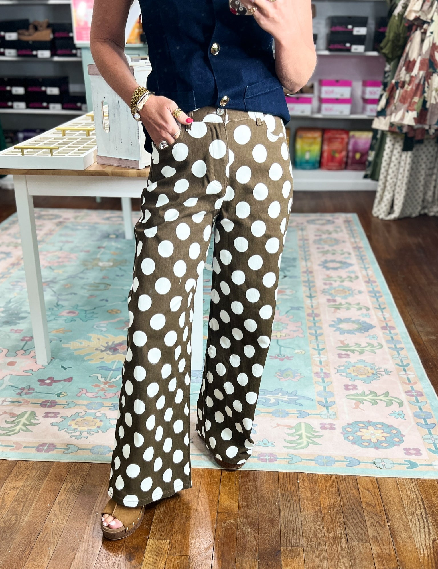 Brown wide-leg pants with large ivory polka dots and flowing straight-to-flare legs
