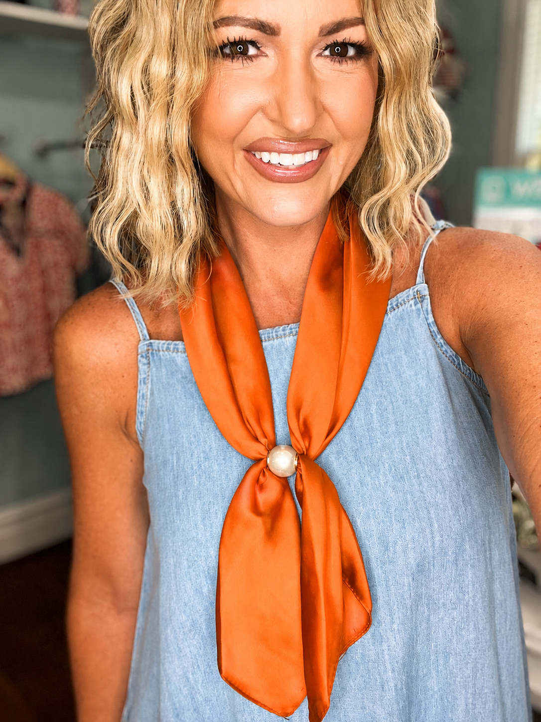 Orange scarf necklace with pearl bead pendant at center