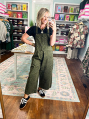 Olive patterned twill overalls with bib front and wide-leg silhouette