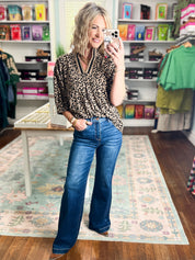 Women's high-rise wide-leg jeans with adjustable waistband, blue denim; full-length view.