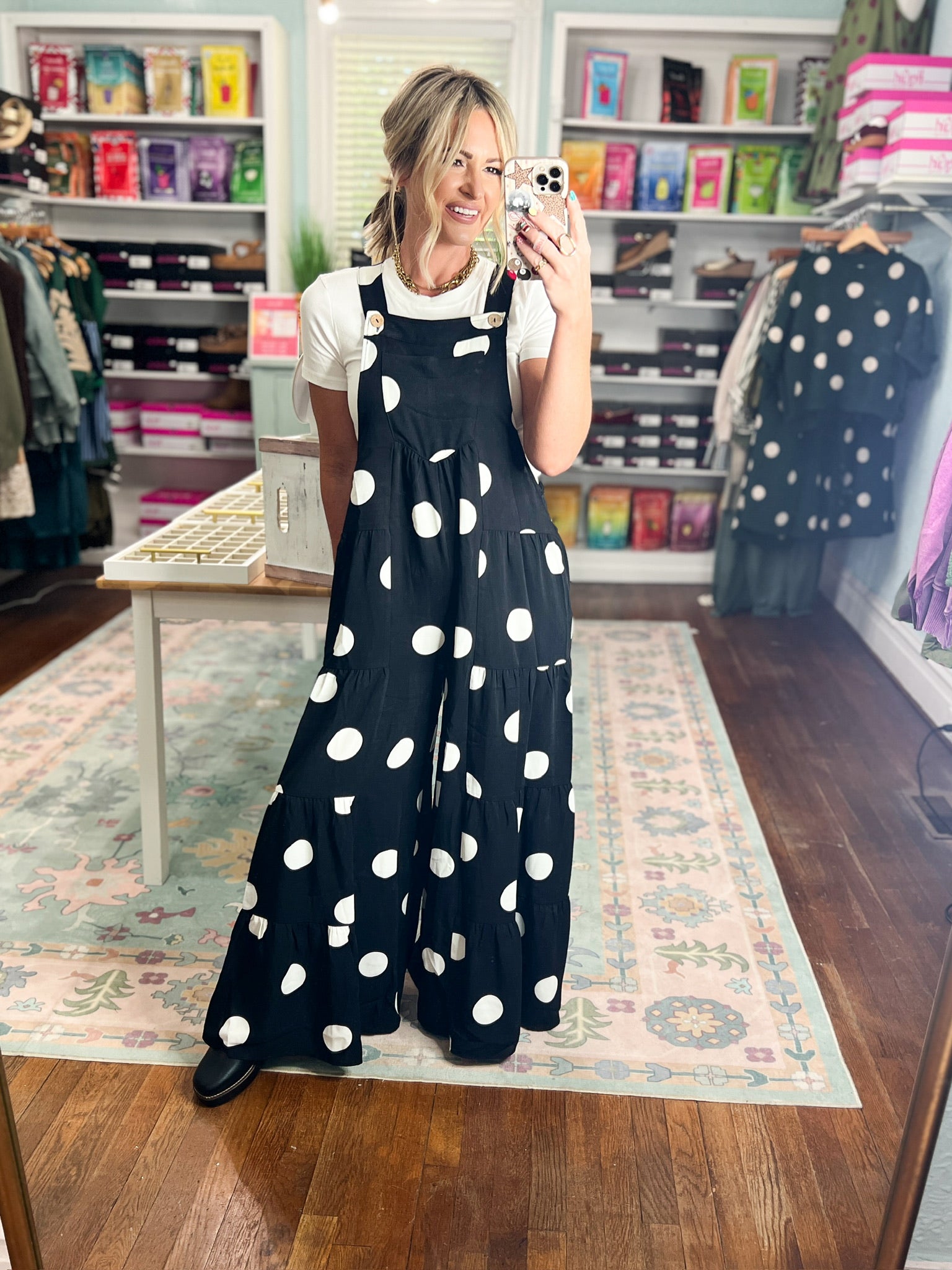 Spotted tiered navy jumpsuit with front bib pockets, long flowing skirted tiers