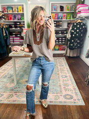 Striped short sleeve V-neck top with brown neckline trim and loose fit