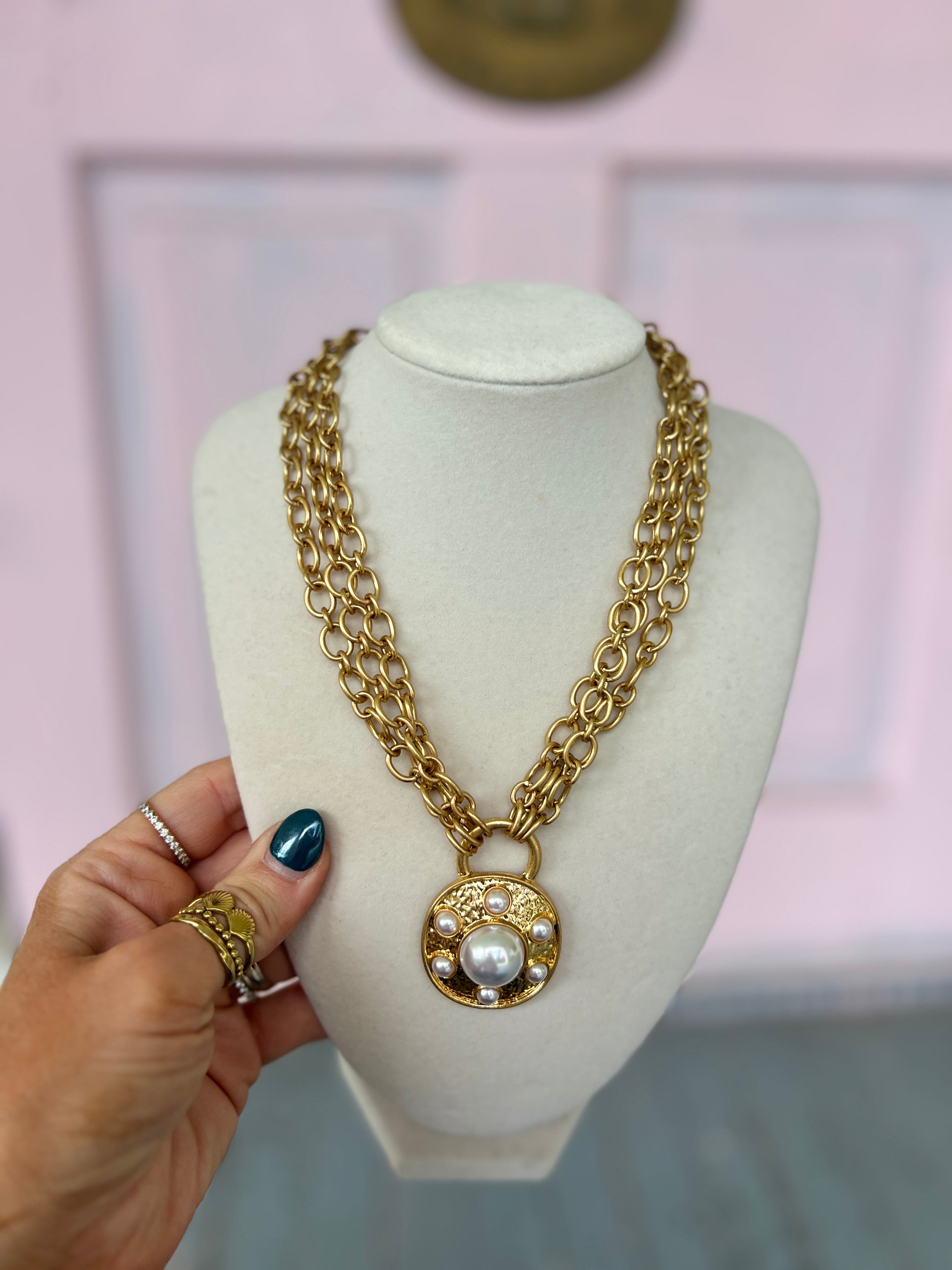 Gold link chain necklace with round pearl medallion pendant