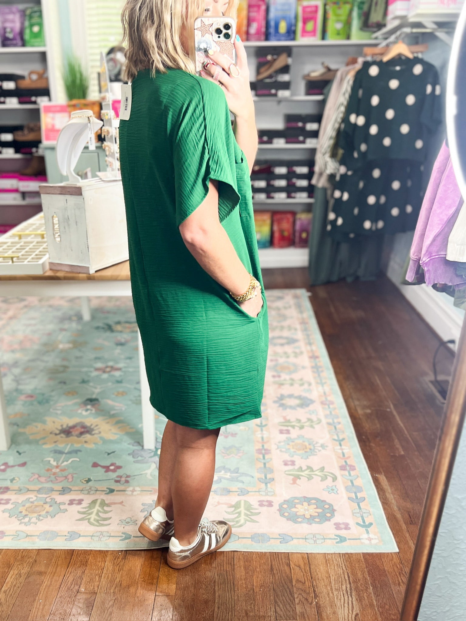 Dark green woven shift dress with short sleeves, V-back, and relaxed fit