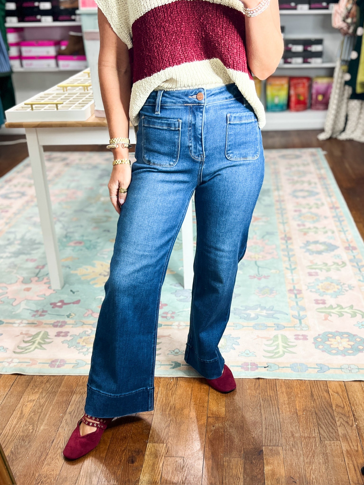 High-rise dark blue wide-leg jeans with front patch pockets, close front view