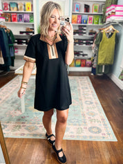 Black shift dress with short sleeves and beige vertical V yoke panel