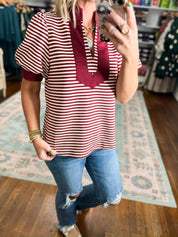 Burgundy and white striped short-sleeve V-neck top with front V trim