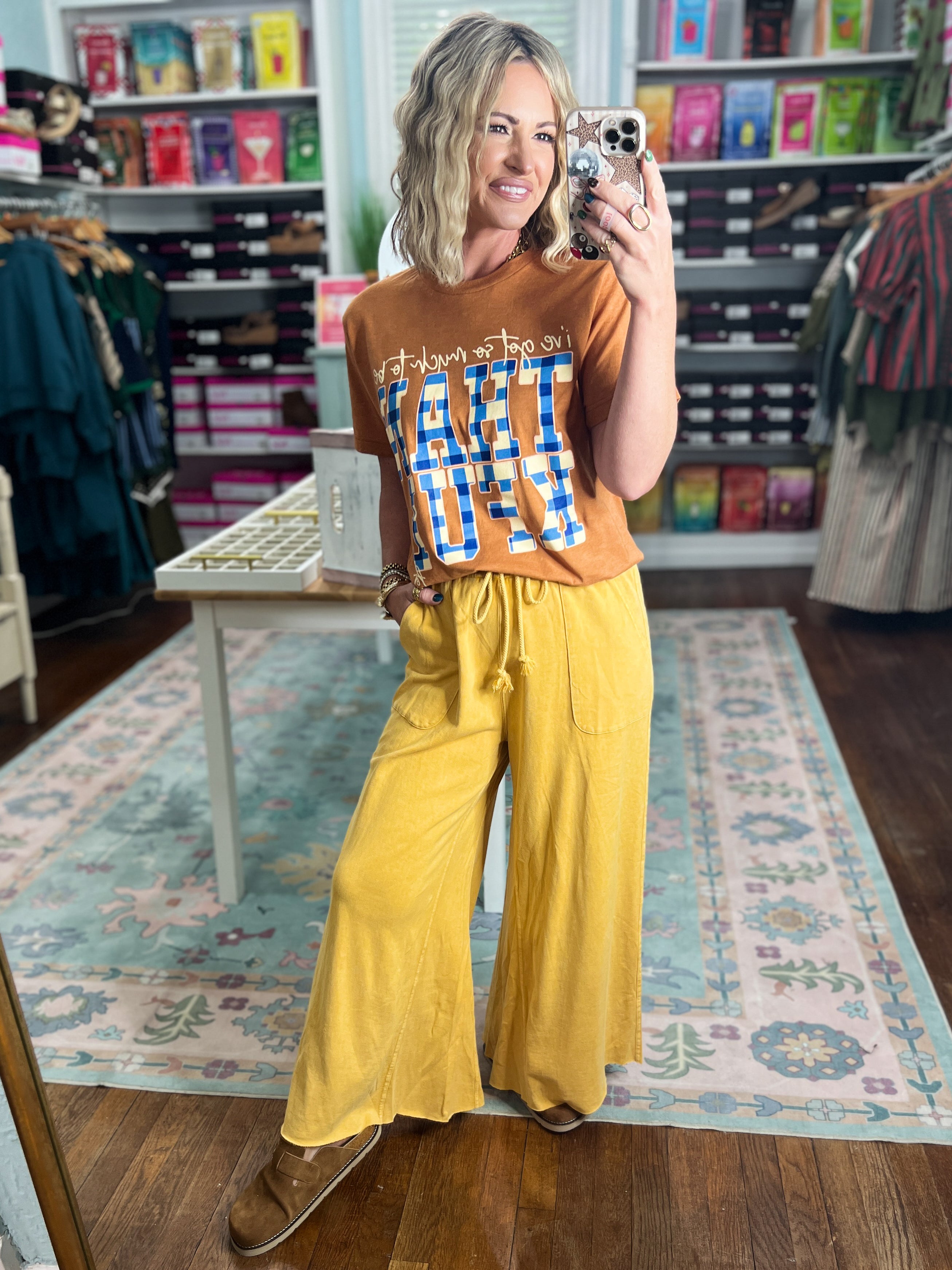 Mustard wide-leg pants with tie waistband and side pockets, loose drape and wide shape.