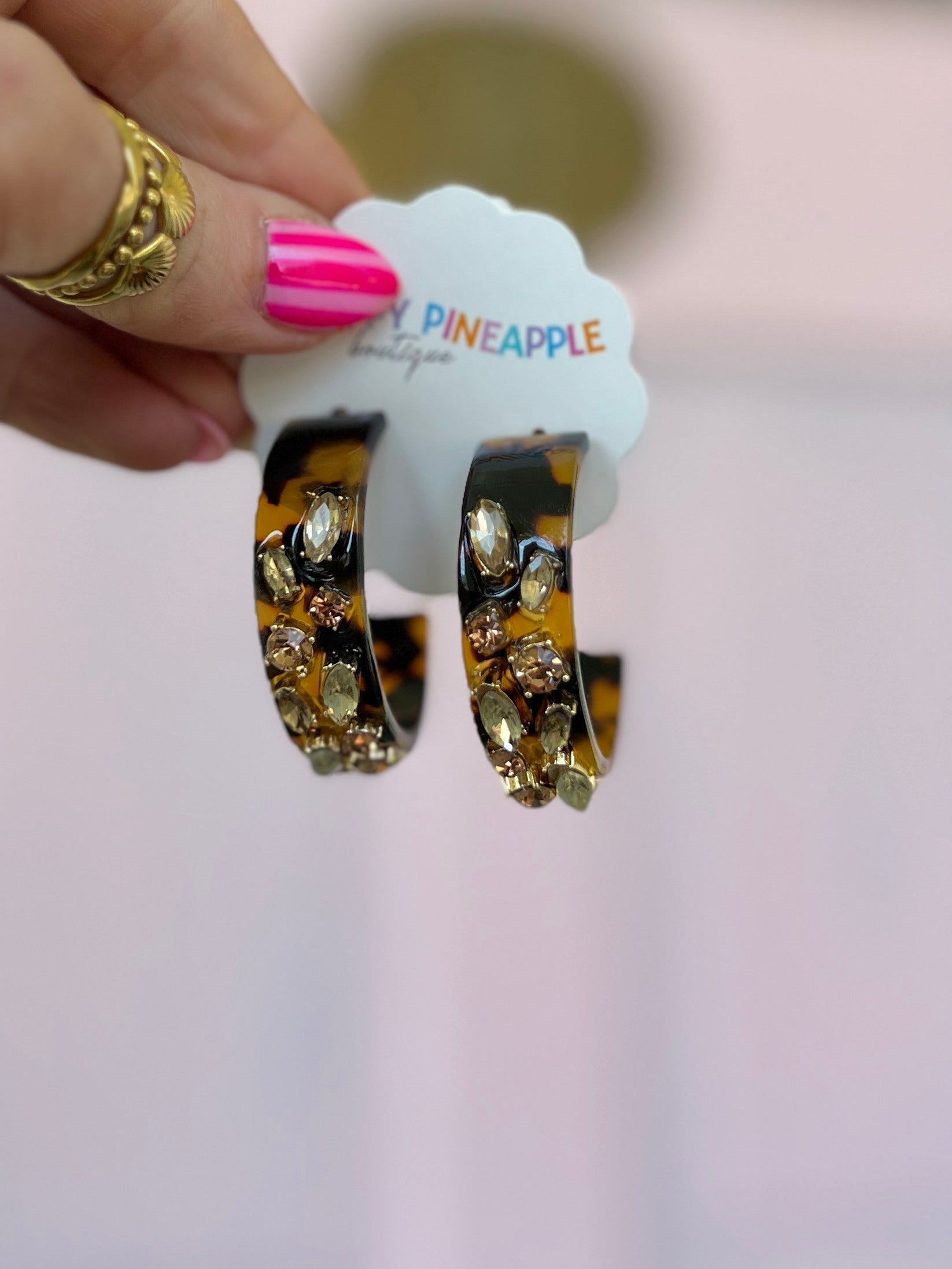 Gold-tone glass-stone acetate hoop earrings with curved oval cluster design