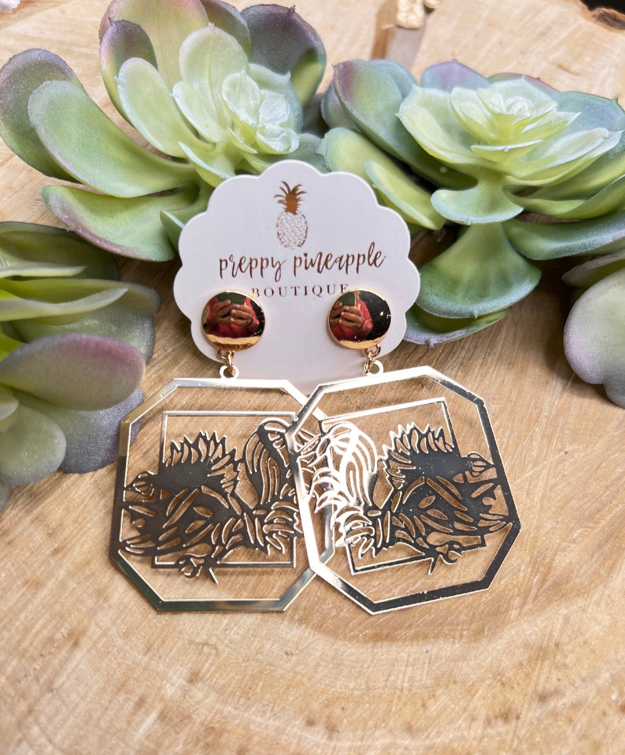 Gold-tone filigree octagon earrings with floral cutout design