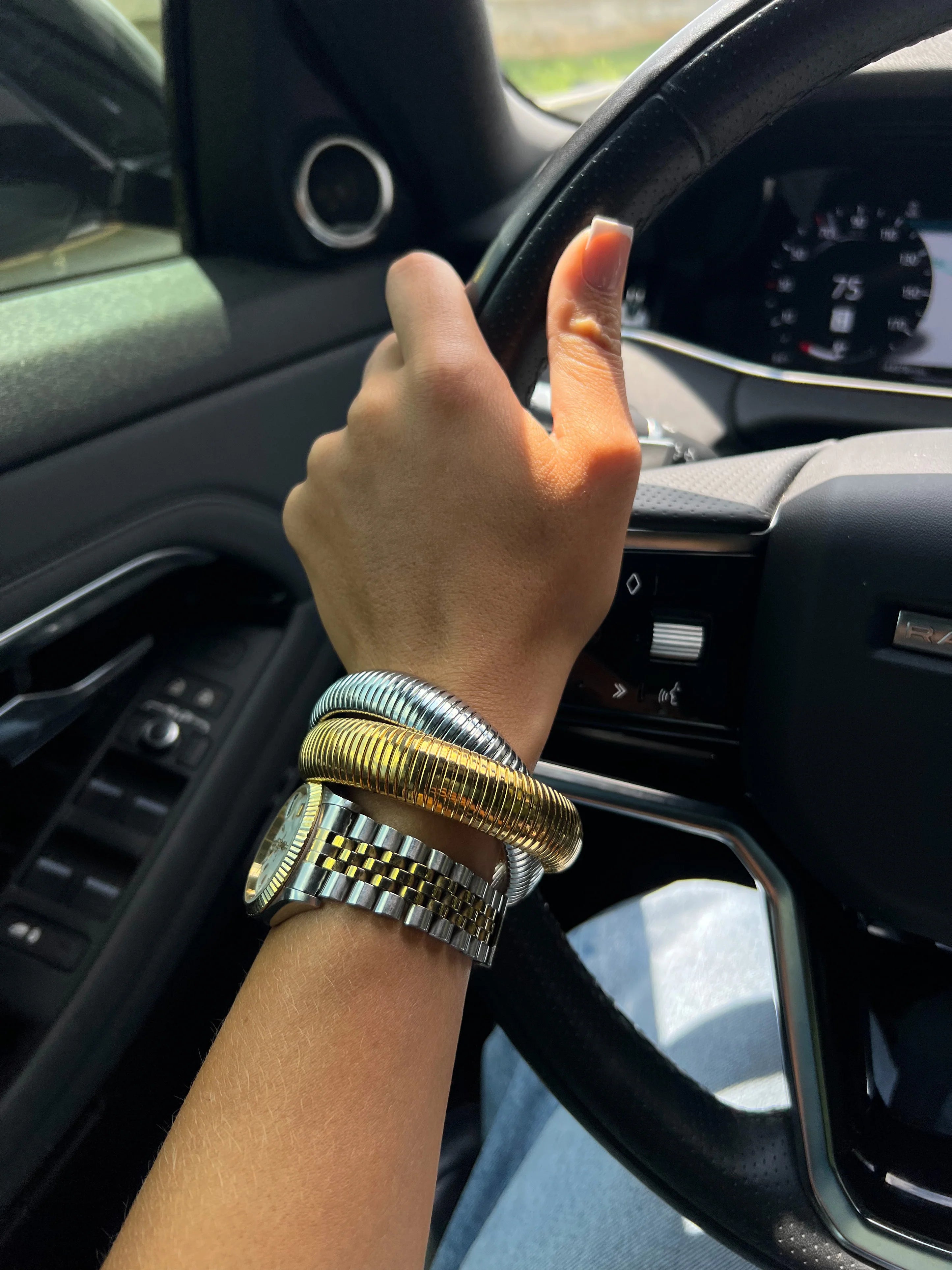 Metal twist bracelet stack with gold and silver bands on wrist