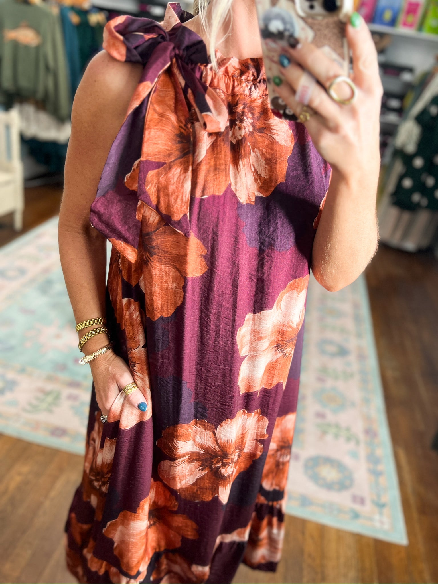 Sleeveless midi dress close-up: burgundy floral print with bow tie at neckline