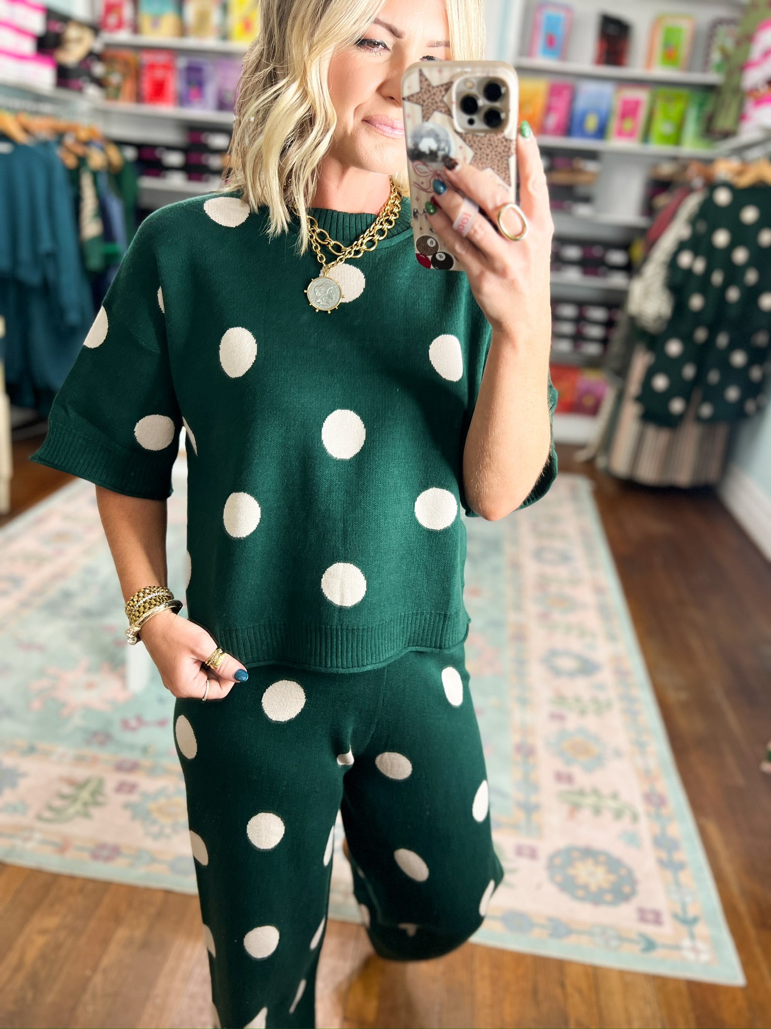 Hunter green polka dot sweater top and pants set, close-up sleeve and neckline