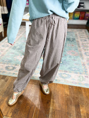 Brown gingham pants shown from the back, with a gathered drawstring waist.