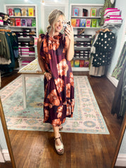 Sleeveless midi dress with burgundy floral pattern and bow-tied sleeveless neckline
