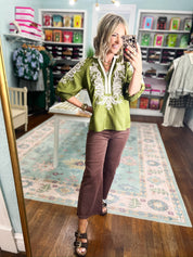 Olive embroidered top featuring white ornate yoke and decorative chest embroidery