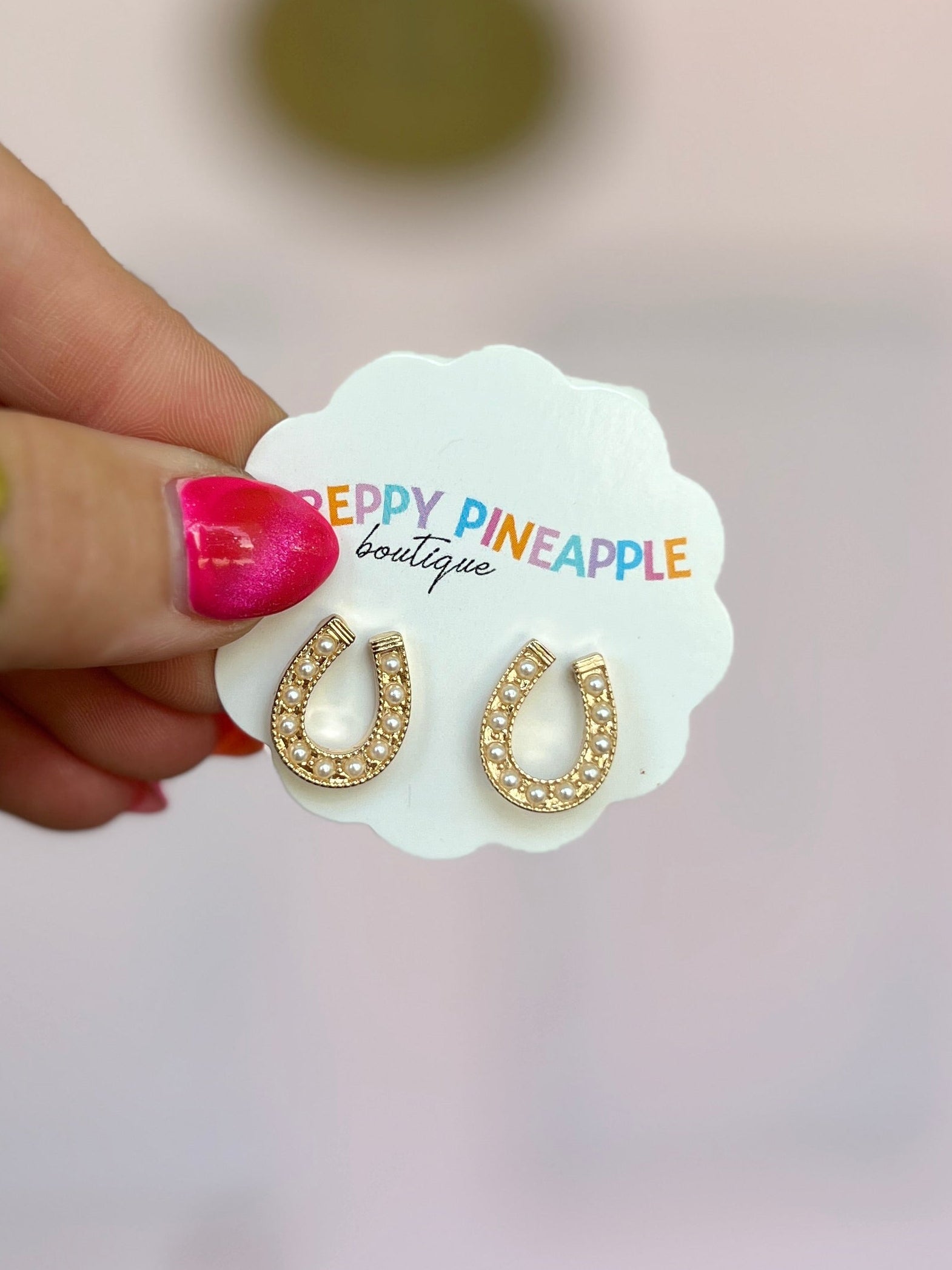 Cream and gold studded horseshoe earrings with rhinestone detailing