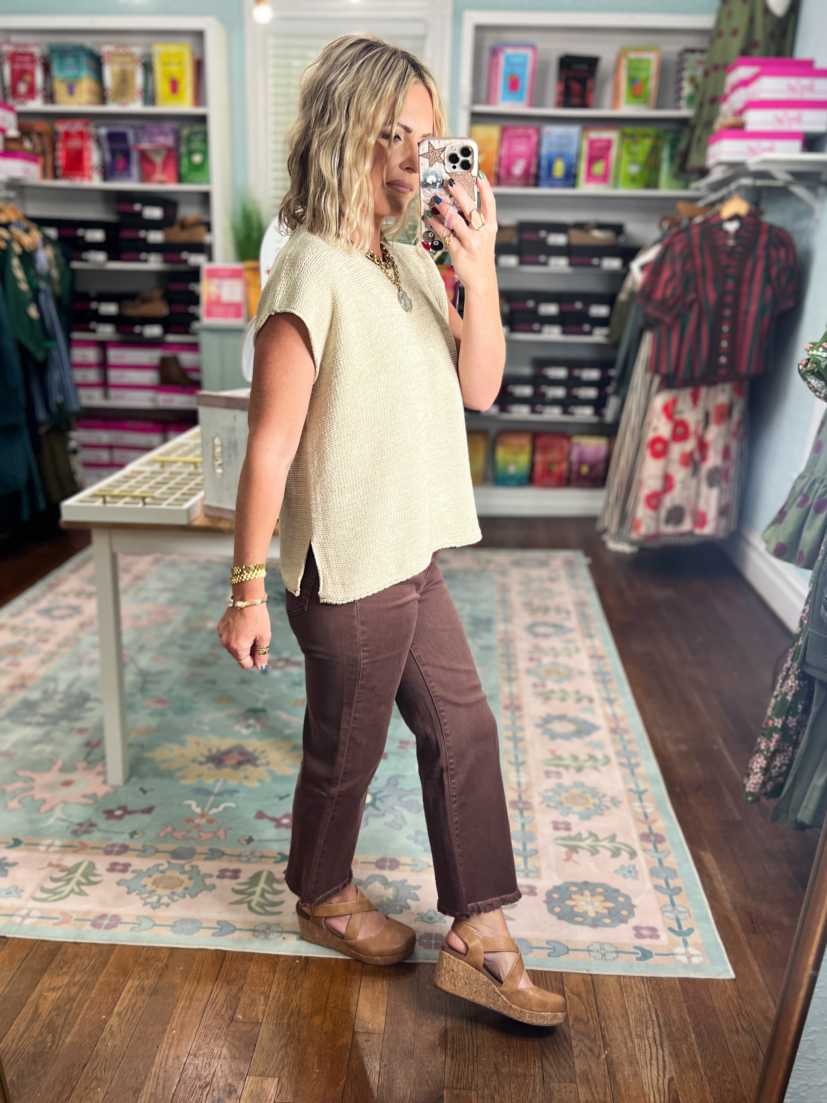 Brown straight pants with frayed ankle hem, side view