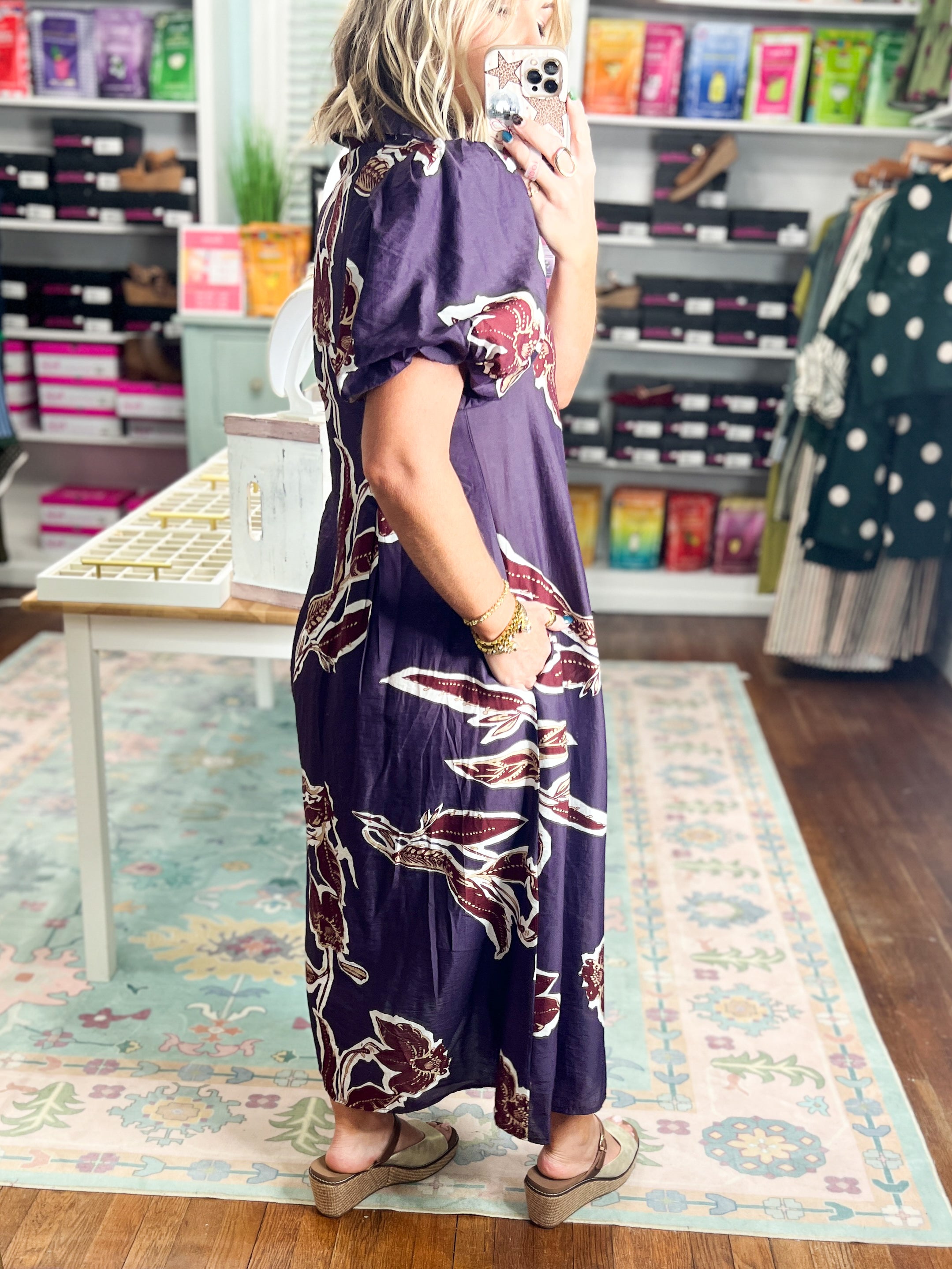 Dark purple puff-sleeve maxi dress with maroon floral print and V-neck, back angle