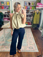 Taupe sleeveless balloon top with gathered high neck and pleated drape
