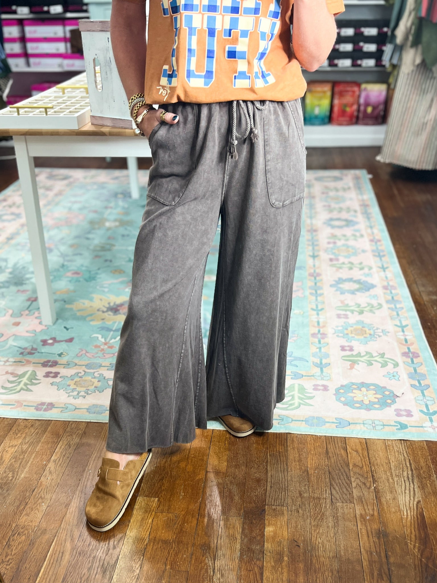 Dark brown wide-leg pants with visible drawstring tie and roomy legs