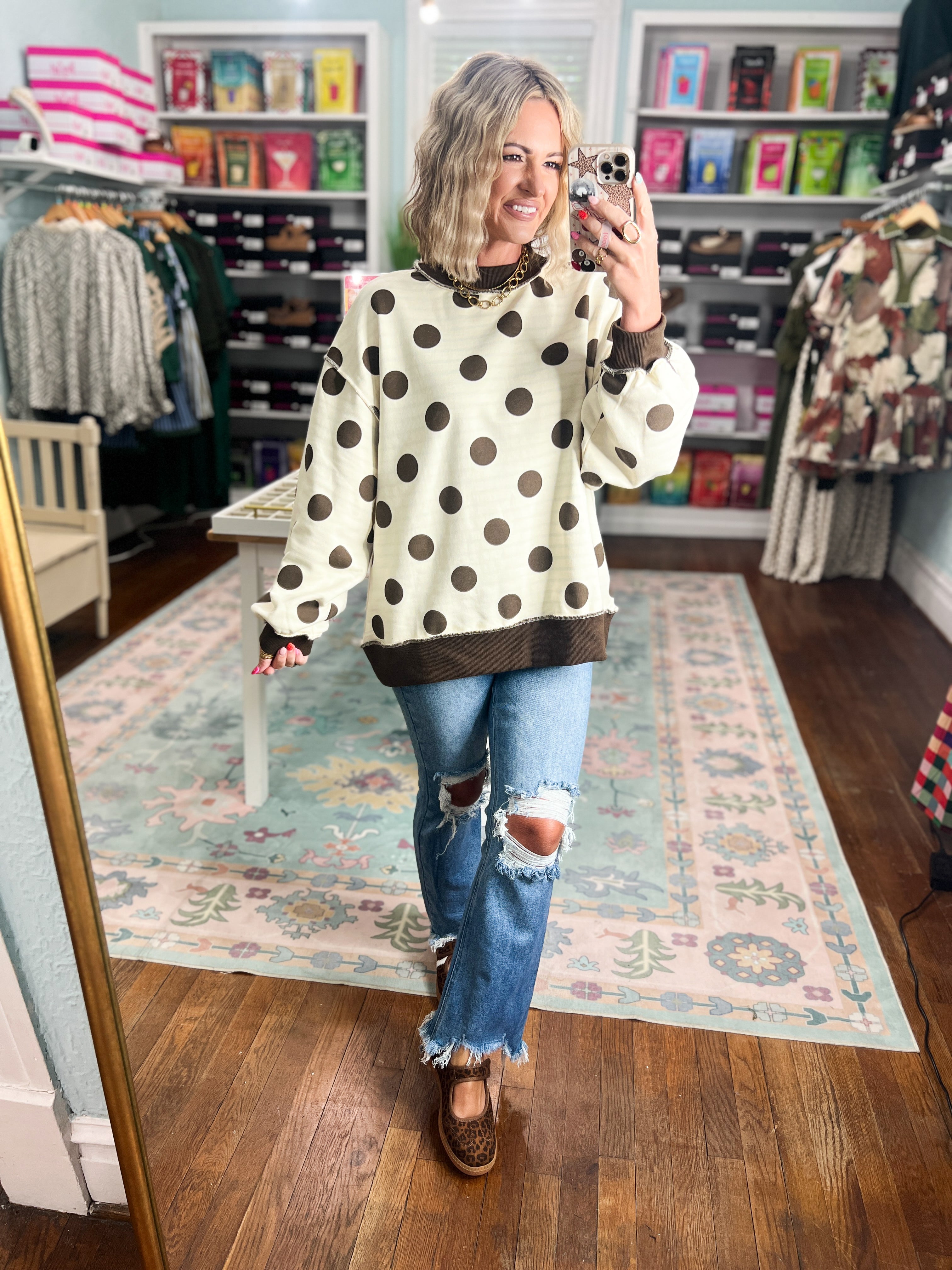Reversible mock neck sweatshirt with ivory polka dots, dark hem, and wide sleeves