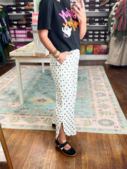 Ivory dot relaxed-fit pants with side-slit hems and wide drape