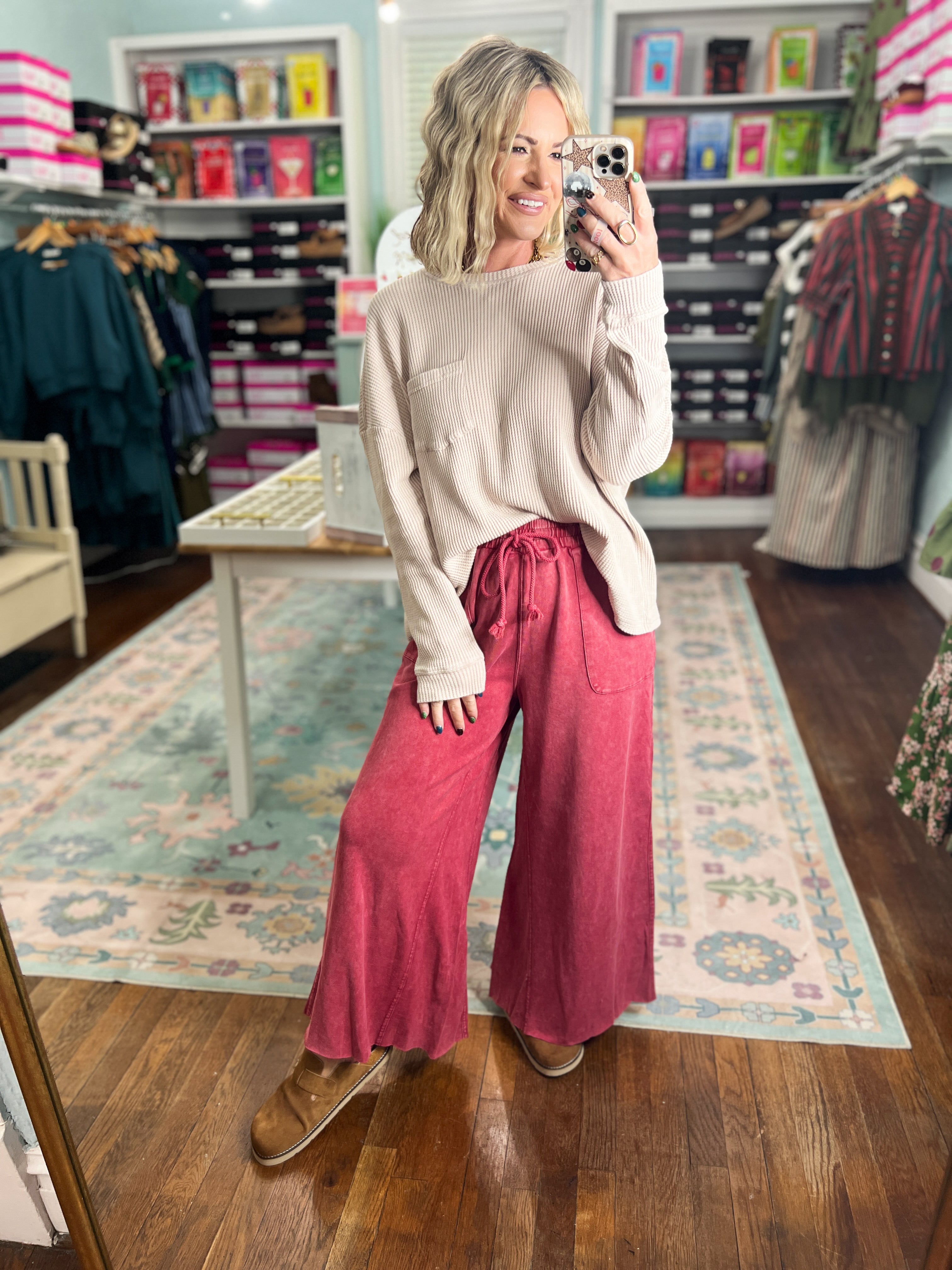 Red wide-leg pants with gathered waistband, relaxed drape, and full length