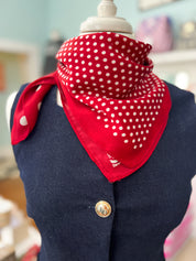 Red bandana scarf with white polka dots and triangular drape