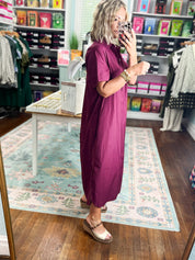 Wine midi dress shown from side; short sleeves and button-front detail