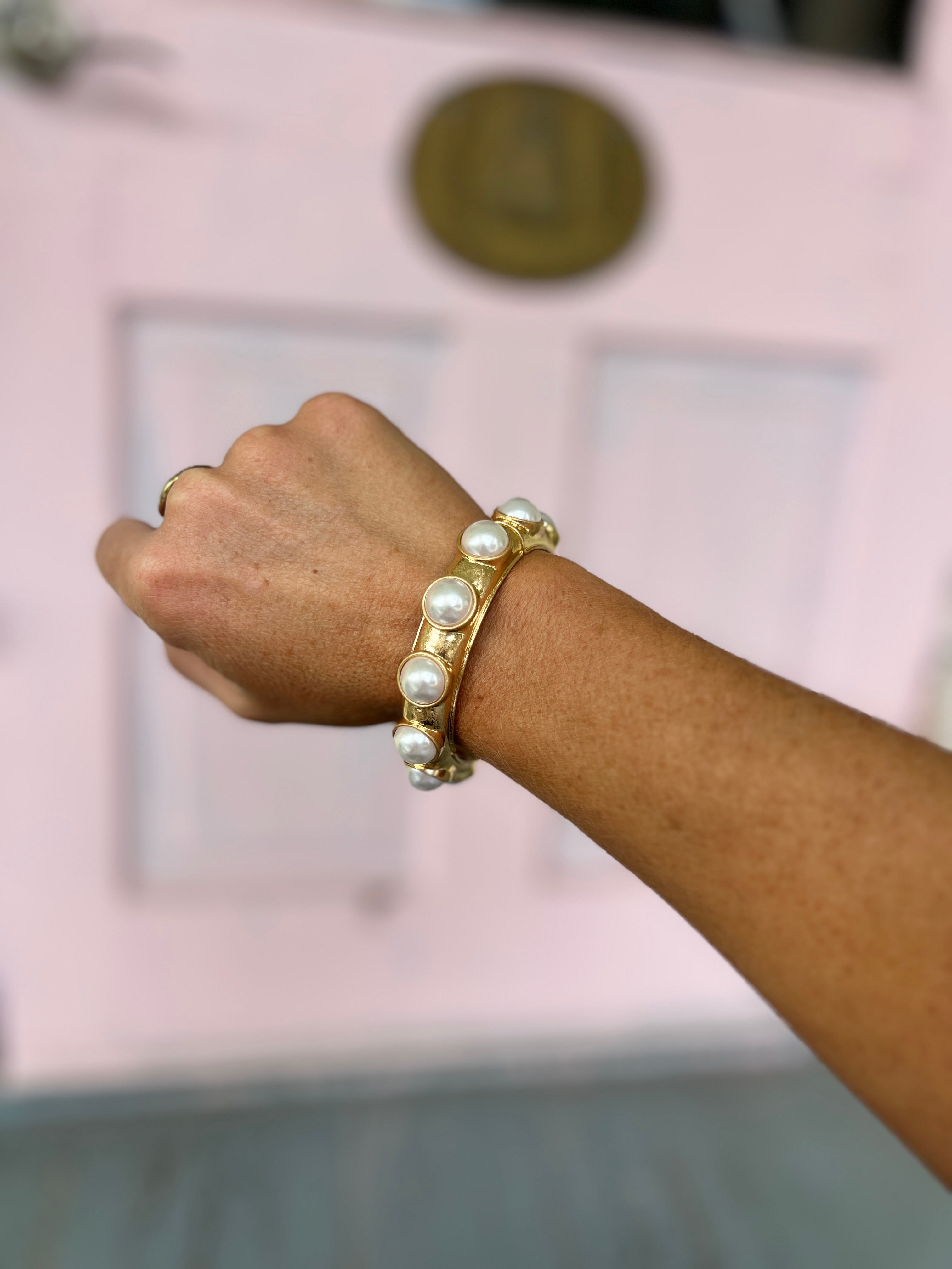 Cream pearl station bracelet with vintage gold-tone round dome links on wrist