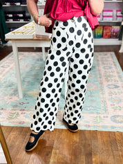 Off-white wide-leg denim pants with black polka dots, front angle