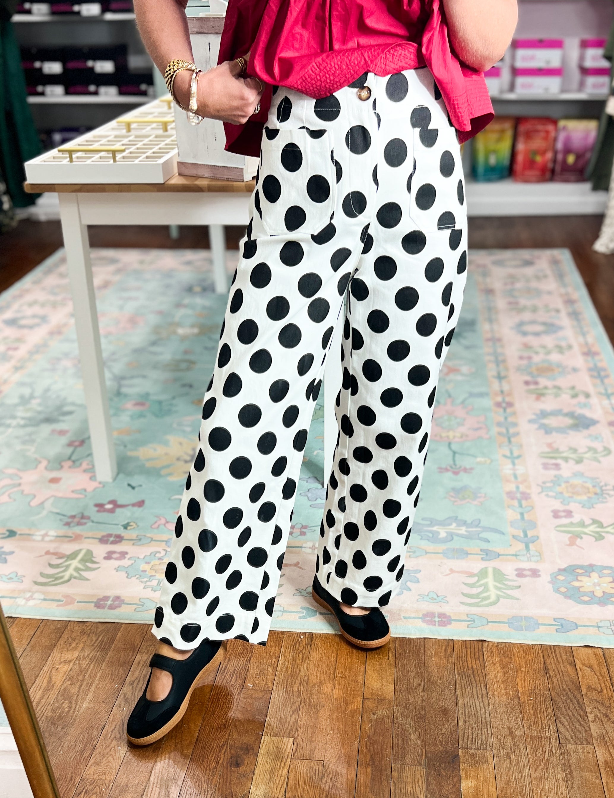 Off-white wide-leg denim pants with black polka dots, front angle