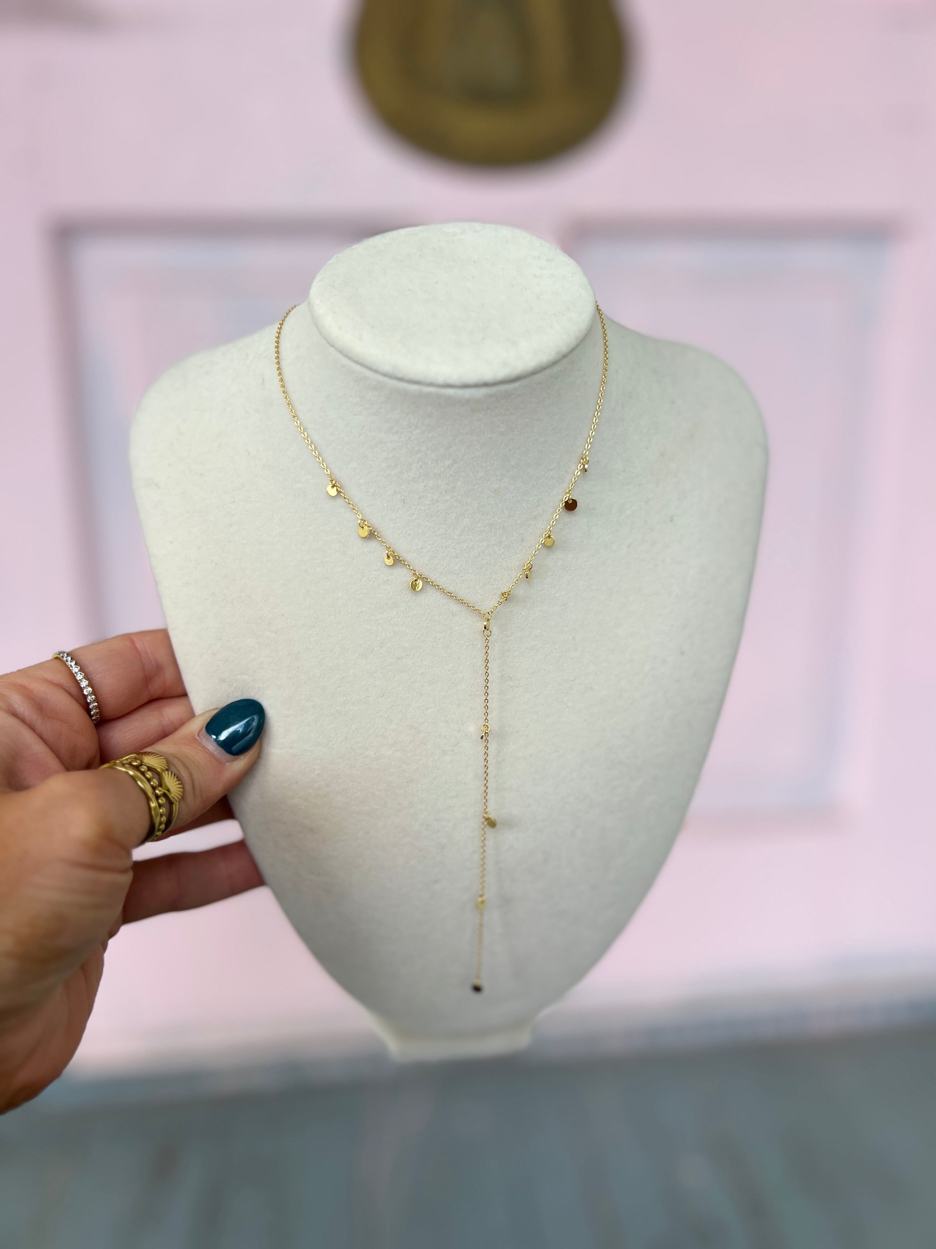 Gold Y-shaped metal necklace with small beaded accents and long drop
