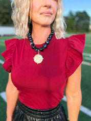 Crimson flutter sleeve top with textured knit and ruffled shoulders