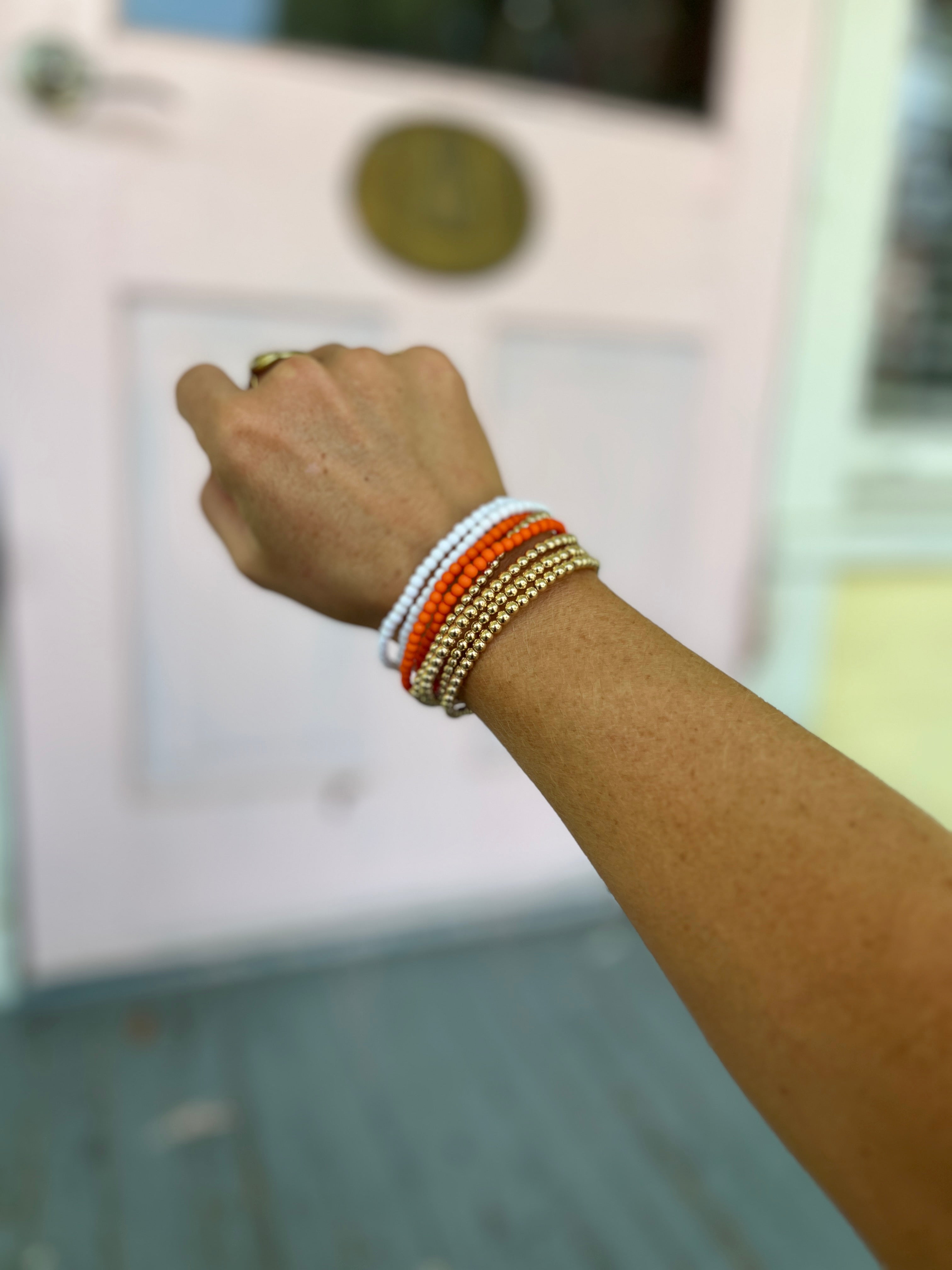 CCB ball and acrylic bead bracelet with orange and white bead clusters, elastic fit
