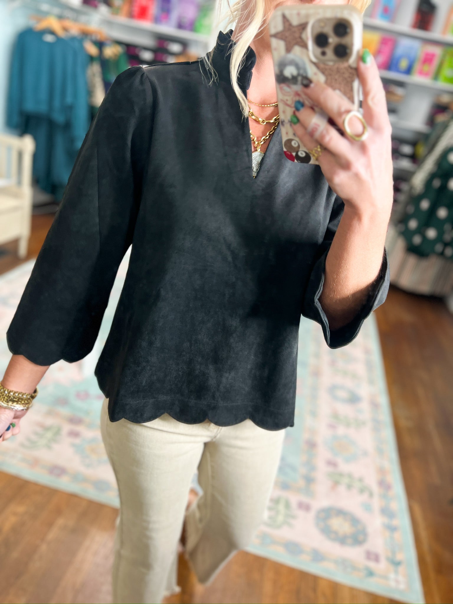 Black faux suede blouse top with mock neck, loose fit, and scalloped hem