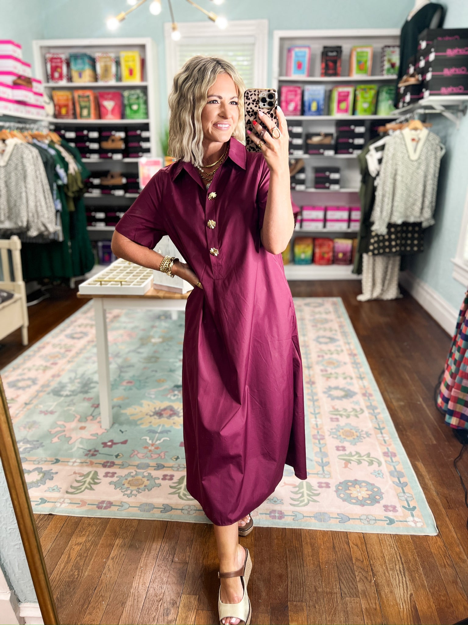 Wine midi dress with button placket and short sleeves, side view in boutique