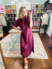 Wine midi dress with button placket and short sleeves, side view in boutique