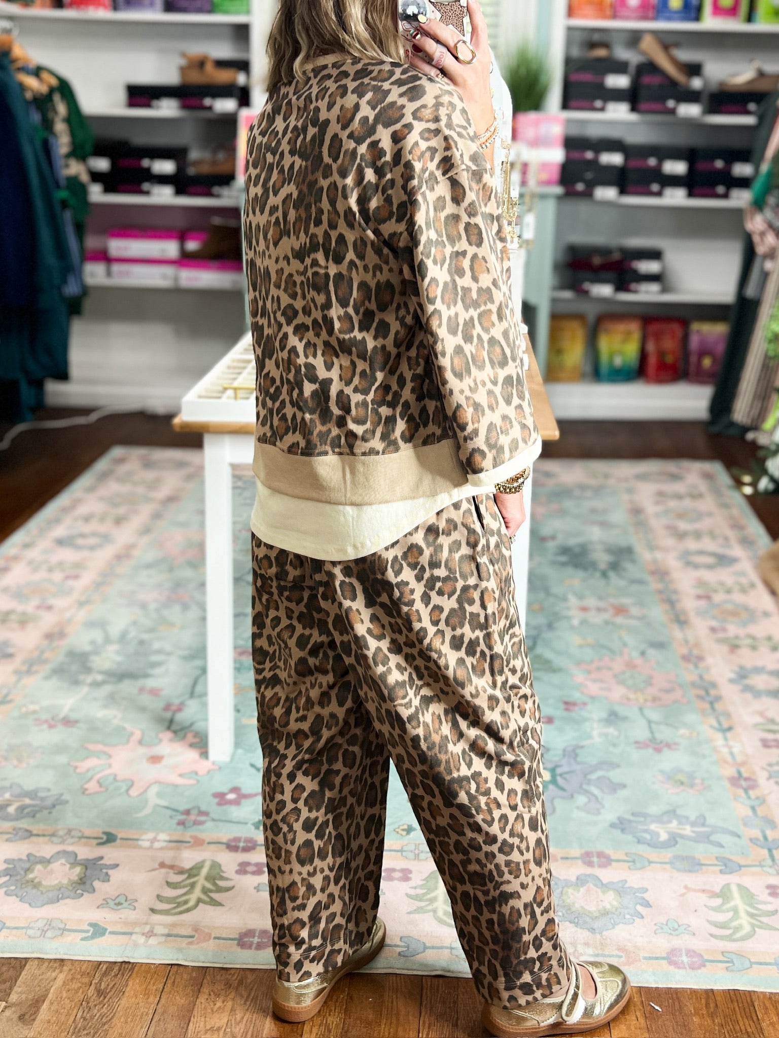 Animal-print top with a loose fit, three-quarter sleeves, and ecru trim, shown from the back