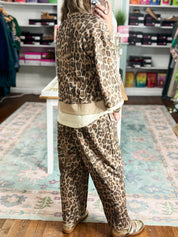 Animal-print top with a loose fit, three-quarter sleeves, and ecru trim, shown from the back