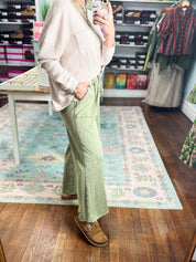 Sage green wide-leg pants with drawstring waist, relaxed fit, side view