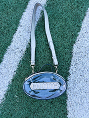 Clear oval football-themed crossbody bag with adjustable straps and zipper top