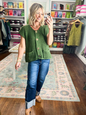 Army green knit button-front sweater with short sleeves, gold buttons, and ribbed waistband